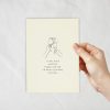 An ivory coloured card with a lineart of champagne wine glasses