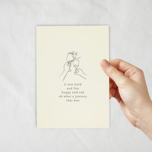 An ivory coloured card with a lineart of champagne wine glasses