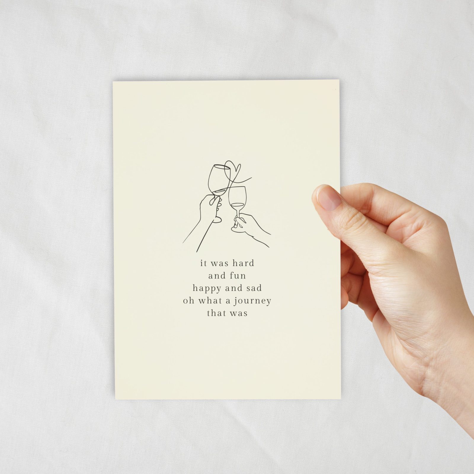 An ivory coloured card with a lineart of champagne wine glasses