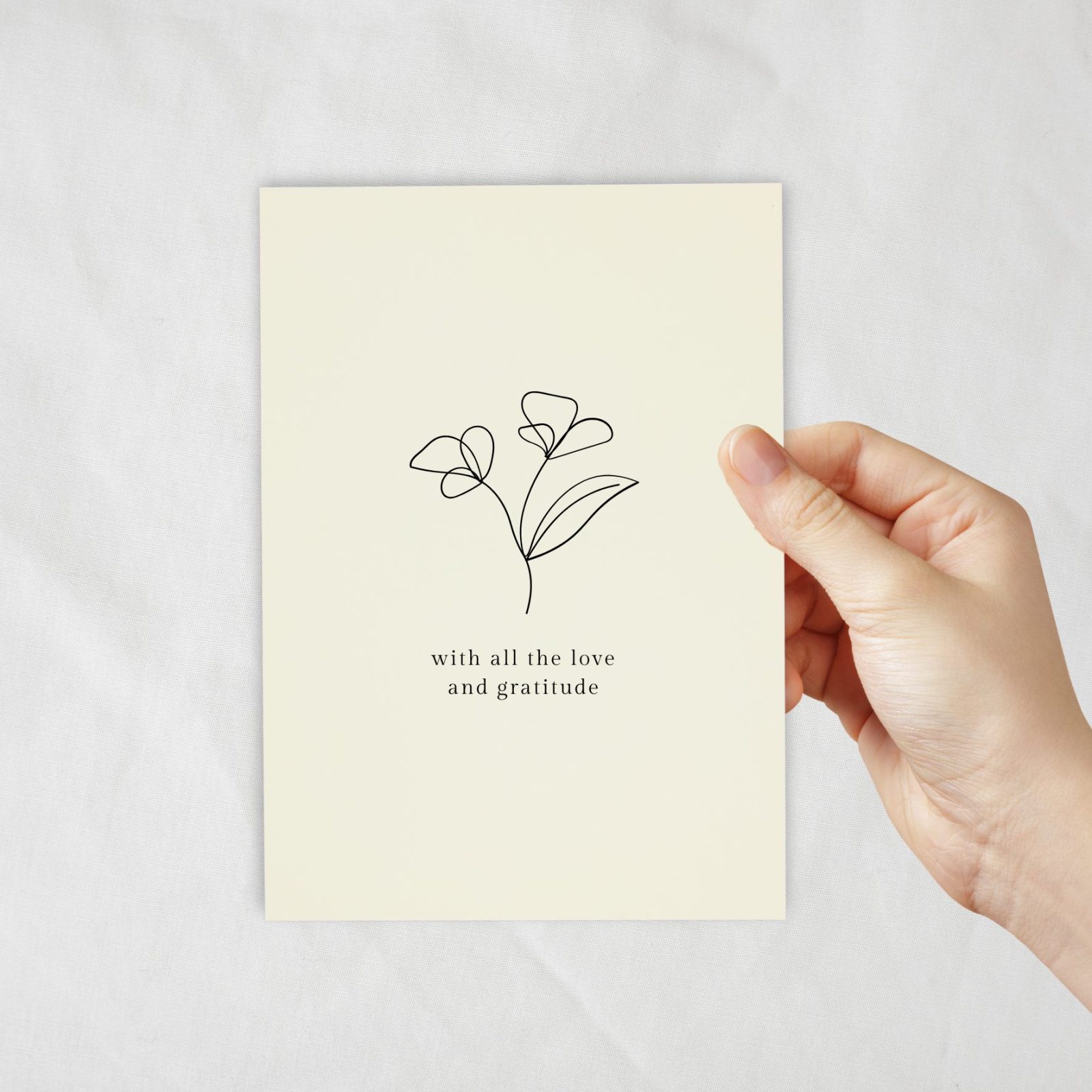 An ivory coloured card with a lineart of flowers with text underneath.