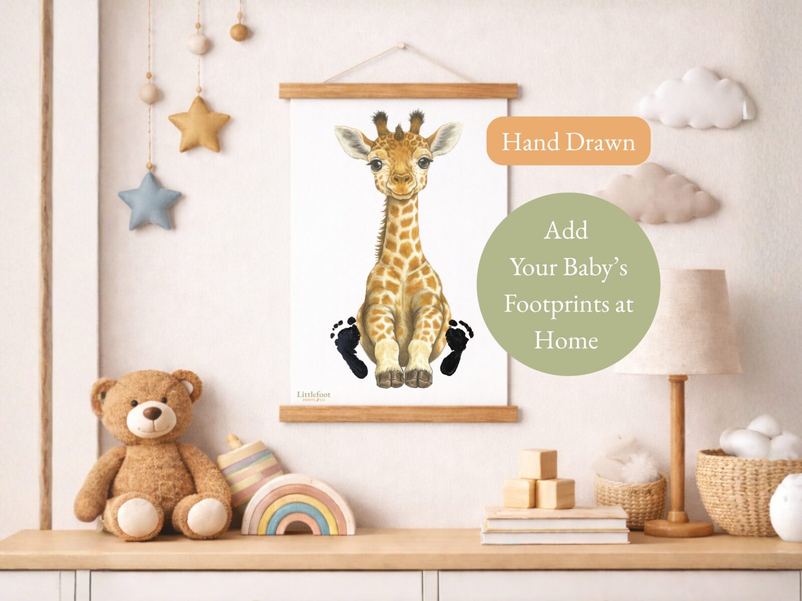 The print of the giraffe hanging on a wall in a child's room, with some words that say the giraffe is hand drawn and you add your baby's footprints to the image.